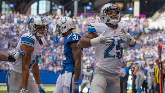 Detroit Lions running back Theo Riddick (25) celebrates his touchdown in the first quarter of the game against the Indianapolis Colts at Lucas Oil Stadium.