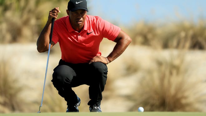 Tiger Woods lines up a putt on the second green during the final round of the Hero World Challenge.