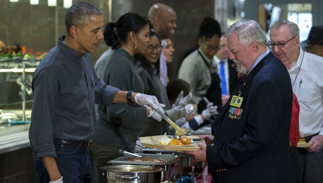 The Obamas serve Thanksgiving dinner to residents at the Armed Forces Retirement Home on Nov. 23, 2016, in Washington.