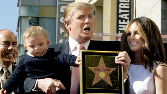 Donald Trump, with his wife, Melania Trump, and their son, Barron, pose for a photo after he was honored with a star on the Hollywood Walk of Fame in Los Angeles in 2007.