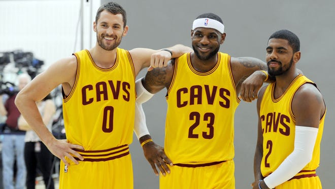 2014: Kevin Love, LeBron James and Kyrie Irving pose for a photo during media day.