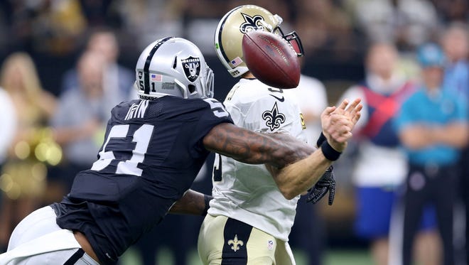 Oakland Raiders linebacker Bruce Irvin (51) strips the ball from New Orleans Saints quarterback Drew Brees (9) in the first quarter at the Mercedes-Benz Superdome.