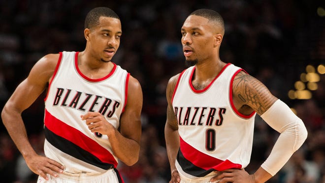 Portland Trail Blazers guards C.J. McCollum (3) and Damian Lillard (0) talk at mid court during the fourth quarter in a game against the Indiana Pacers.
