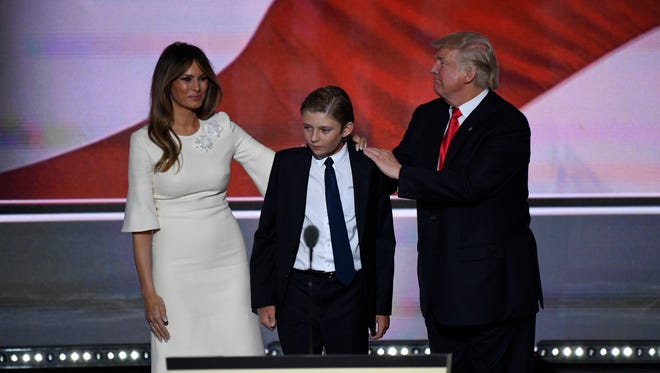 Donald Trump stands with his wife, Melania, and son Barron after he spoke during the Republican National Convention in Cleveland on July 21, 2016.