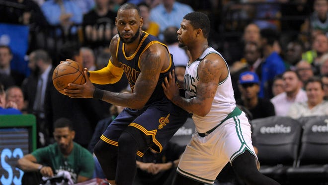 Cleveland Cavaliers forward LeBron James controls the ball while being guarded by Boston Celtics guard Marcus Smart during the first half in game one of the Eastern conference finals of the NBA Playoffs at TD Garden.