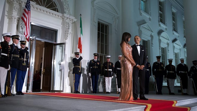 The Obamas wait to greet Italian Prime Minister Matteo Renzi and Italian First Lady Agnese Landini prior to the state dinner at the White House on Oct. 18, 2016.