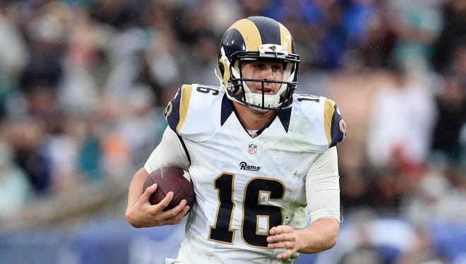 Los Angeles Rams quarterback Jared Goff (16) runs the ball against the Miami Dolphins during the second half at Los Angeles Memorial Coliseum.