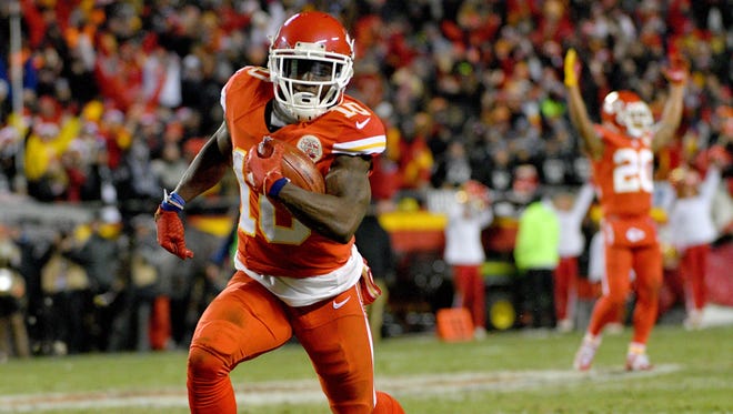 Kansas City Chiefs wide receiver Tyreek Hill (10) returns a punt for a touchdown during the first half against the Oakland Raiders at Arrowhead Stadium.