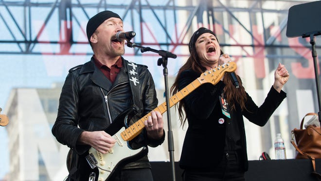 The Edge and Juliette Lewis perform onstage at the Women's March in Los Angeles, Saturday.