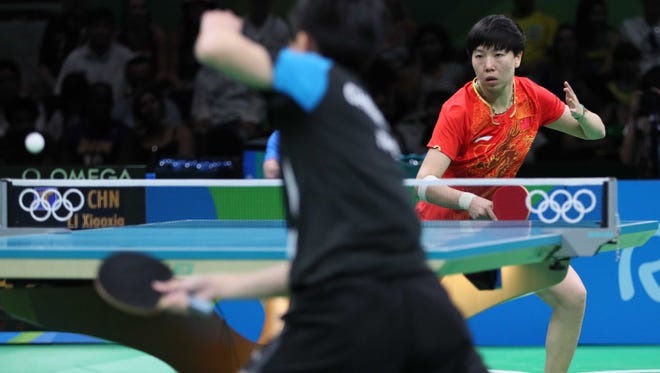 I-Ching Cheng of Chinese Taipei faces off against Xiaoxia Li of China during women's singles table tennis quarterfinals in the Rio 2016 Summer Olympic Games at Riocentro - Pavilion 3.