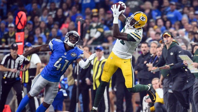 Packers wide receiver Geronimo Allison (81) catches a pass while being pressured by Lions cornerback Crezdon Butler (41) during the fourth quarter.