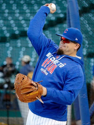 Kyle Schwarber throws  during workouts before the start of the NLCS.