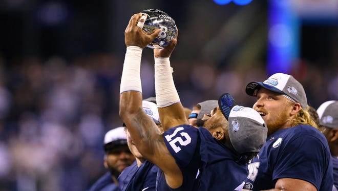 Penn State wide receiver Chris Godwin (12) reacts after receiving the Big Ten championship trophy.