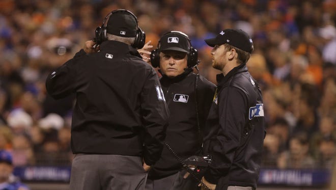 Game 3 in San Francisco: Umpires review a play in the sixth inning.