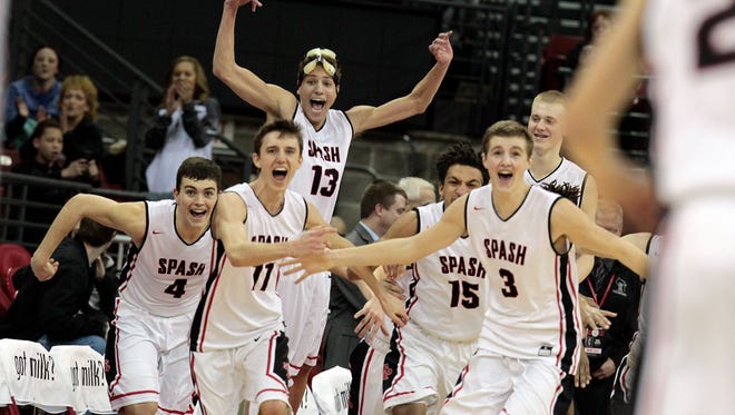 Stevens Point players jump at the buzzer to celebrate their 85-56 win over Arrowhead.