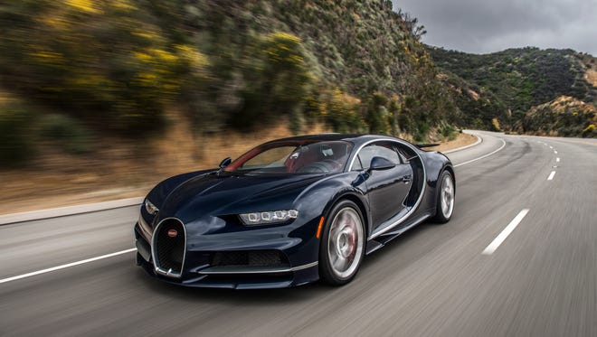 The Bugatti Chiron takes a corner on an open road.