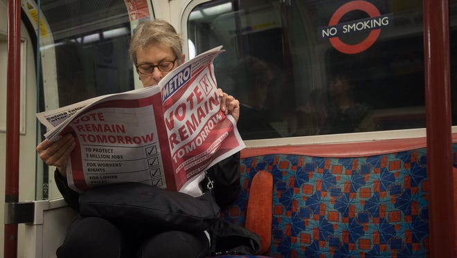 A woman reads a British newspaper backing the 'Vote Remain' campaign on the London Underground on June 22, 2016.