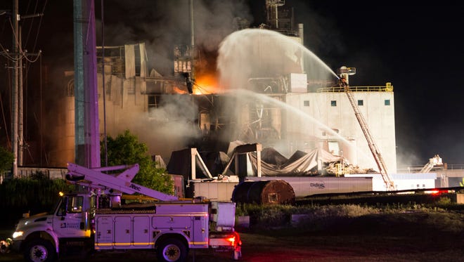 In this photo provided by Jeff Lange, firefighters work the scene following an explosion and fire at the Didion Milling plant in Cambria, Wis., Thursday, June 1, 2017. Recovery crews searched a mountain of debris on Thursday following a fatal explosion late Wednesday at the corn mill plant, which injured about a dozen people and leveled parts of the sprawling facility in southern Wisconsin, authorities said.
