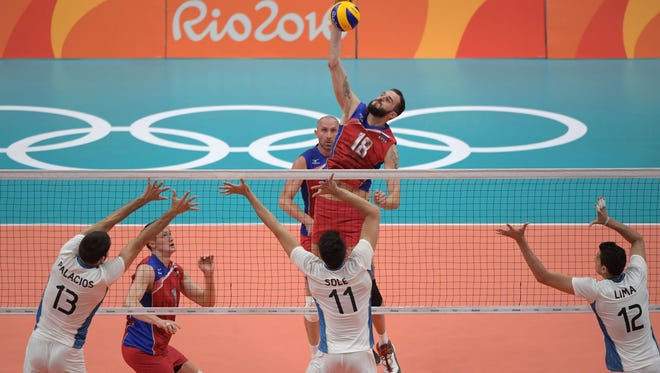 Alexander Volkov of Russia hits over Sebastian Sole of Argentina in a men's preliminary round Group B match at Maracanazinho during the Rio 2016 Summer Olympic Games.