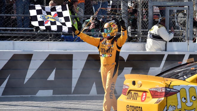 Kyle Busch celebrates after winning the STP 500 at Martinsville Speedway, his first victory of the 2016 season.