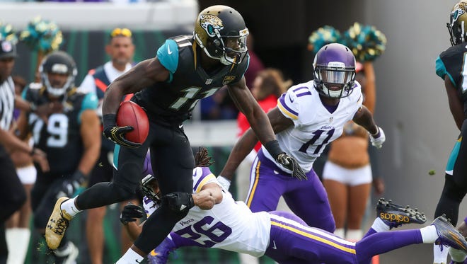 Jacksonville Jaguars wide receiver Marqise Lee (11) returns a kickoff in the first quarter as Minnesota Vikings cornerback Trae Waynes (26) defends at EverBank Field.