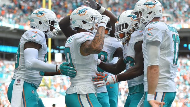 Miami Dolphins wide receiver Kenny Stills (10) celebrates with teammates after scoring a touchdown against the Arizona Cardinals during the first half at Hard Rock Stadium.
