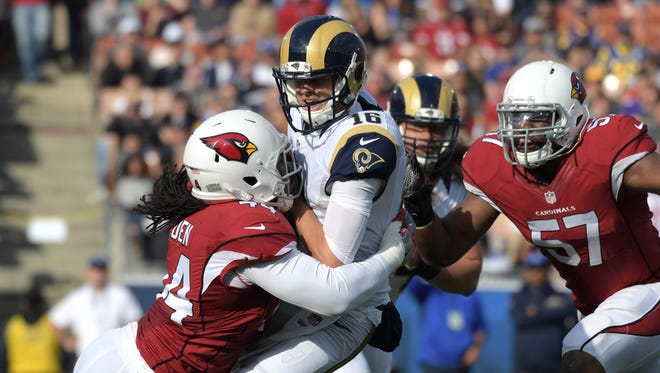 Rams quarterback Jared Goff (16) is sacked by Cardinals linebackers Sio Moore (54) and Alex Okafor (57) in the first quarter.