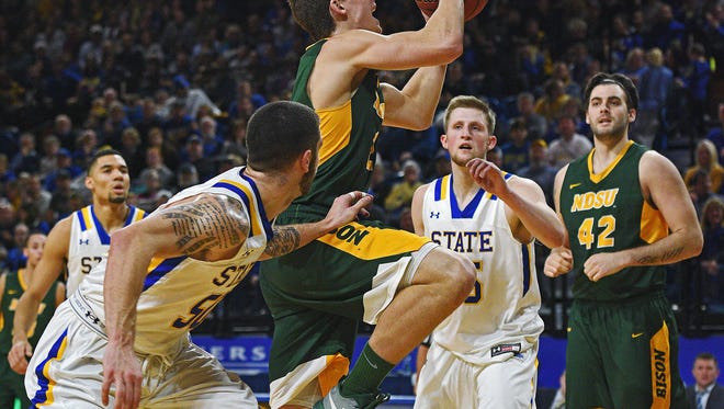 NDSU's Paul Miller (2) goes up for a shot as SDSU's Michael Orris (50) defends during a game Wednesday, Dec. 28, 2016, at Frost Arena on the South Dakota State University campus in Brookings, S.D.