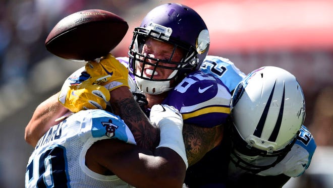 Tennessee Titans inside linebacker Wesley Woodyard (59) and strong safety Da'Norris Searcy crush Minnesota Vikings tight end Kyle Rudolph (82).