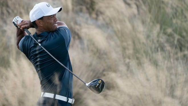 Tiger Woods hits his tee shot on the third hole during the third round of the Hero World Challenge golf tournament at Albany.
