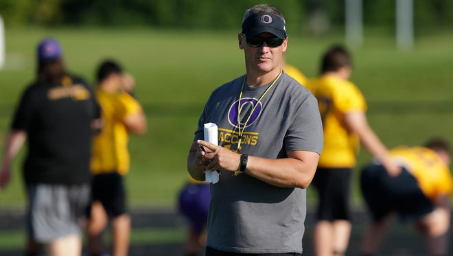 Oconomowoc coach Greg Malling supervises his team Tuesday on the first day of football practice.