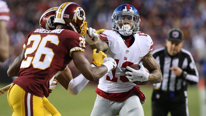 Giants wide receiver Odell Beckham Jr. (13) runs with the ball as Redskins cornerbacks Josh Norman (24) and Bashaud Breeland (26) chase in the second quarter.