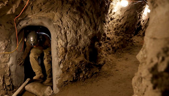 A member of the Border Patrol's Border Tunnel Entry Team enters a tunnel spanning the border between San Diego and Tijuana, Mexico.