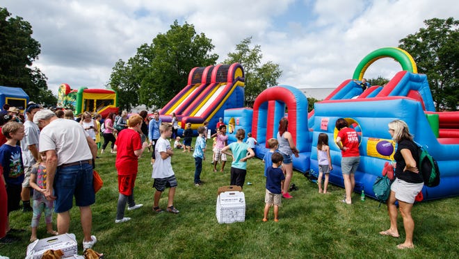 Kids enjoy a maze of inflatables during Oconomowoc Kid's Fest at Roosevelt Park on Tuesday, Aug. 15, 2017.