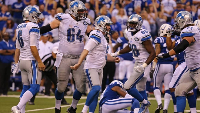 Detroit Lions kicker Matt Prater (5) celebrates with teammates after hitting the game-winning field goal against the Indianapolis Colts.