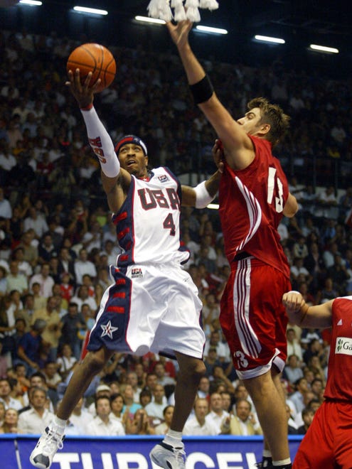 Allen Iverson goes up for a lay up as Turkey's center Mehmet Okur defends.