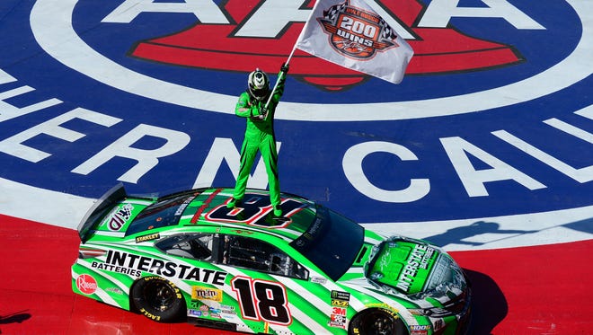Kyle Busch celebrates on top of his Joe Gibbs Racing Camry after winning the Auto Club 400 on March 17, 2019, for his 200th combined NASCAR national series victory.
