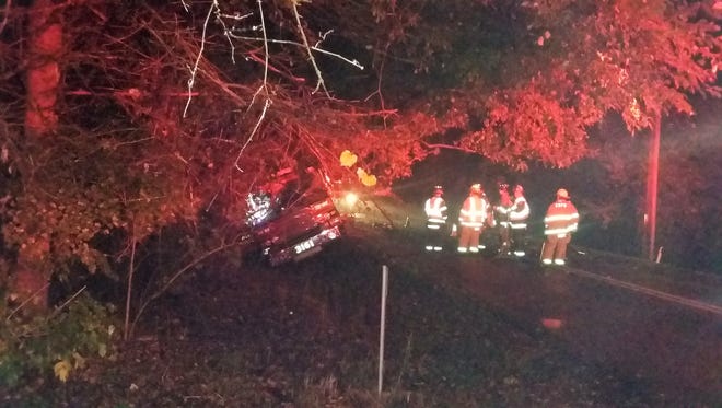 Firefighters talk near a town of Delafield fire truck that crashed while responding to a call around 2 a.m. Oct. 14 along Silvernail Road. An estimate of repair costs was not immediately available, but should be covered by the department's insurance.