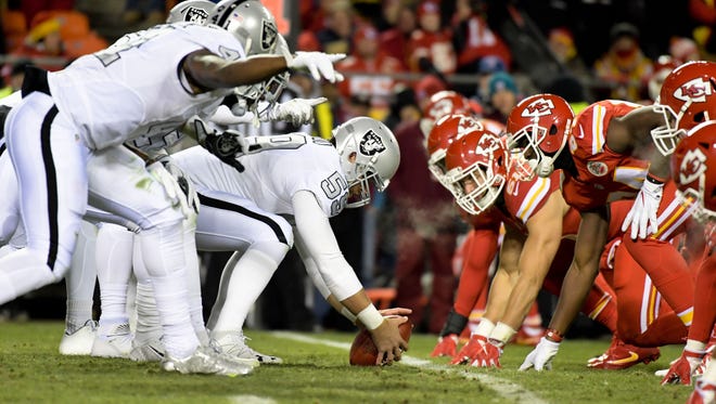 Oakland Raiders at the line against the Kansas City Chiefs during a NFL football game at Arrowhead Stadium.