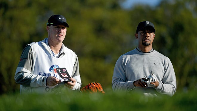 Tiger Woods and caddie Joe LaCava look on during the Zurich Pro-Am of the  Farmers Insurance Open on Jan. 25.