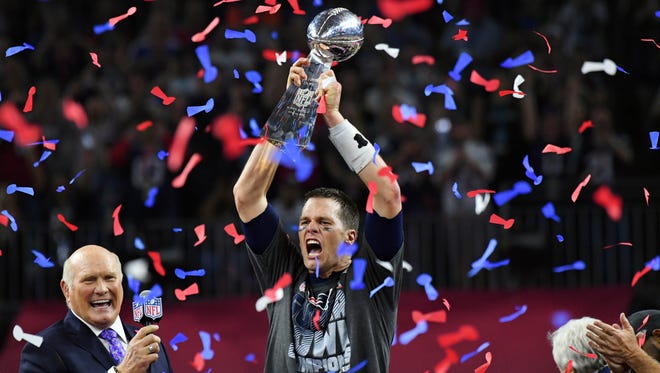 New England Patriots quarterback Tom Brady celebrates with the Vince Lombardi Trophy after defeating the Atlanta Falcons 34-28 in Super Bowl LI at NRG Stadium.