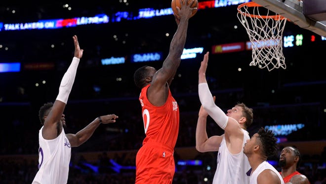 Clippers forward Brandon Bass (30) moves to the basket against Lakers center Timofey Mozgov (20) during the first half.