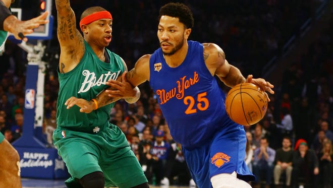 New York Knicks guard Derrick Rose (25) dribbles the ball while being defended by Boston Celtics guard Isaiah Thomas (4) during the first half at Madison Square Garden.