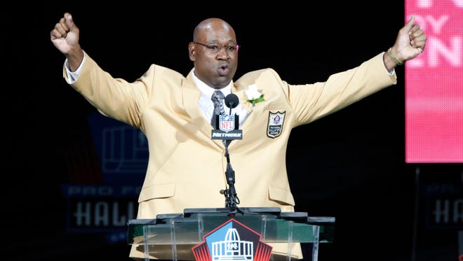 Former NFL player Cortez Kennedy gestures during his induction at the Pro Football Hall of Fame on Saturday, Aug. 4, 2012.