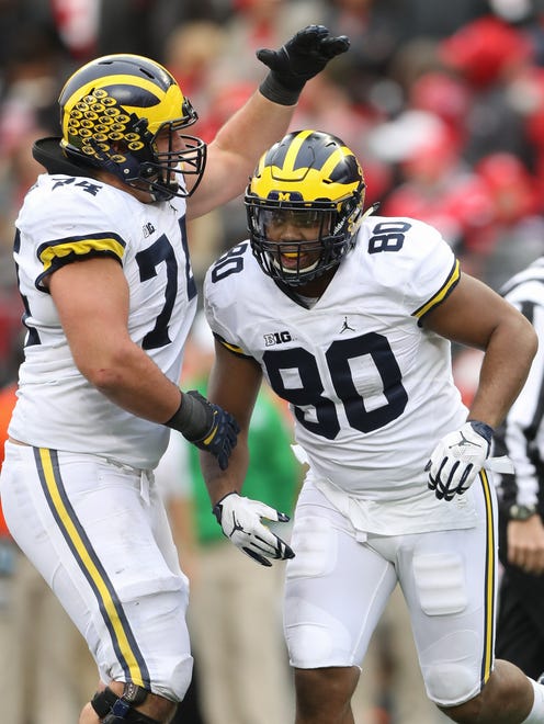 Michigan's Ben Bredeson, left, and Khalid Hill celebrate a touchdown against Ohio State in the second half Saturday, Nov. 26, 2016 at Ohio Stadium.