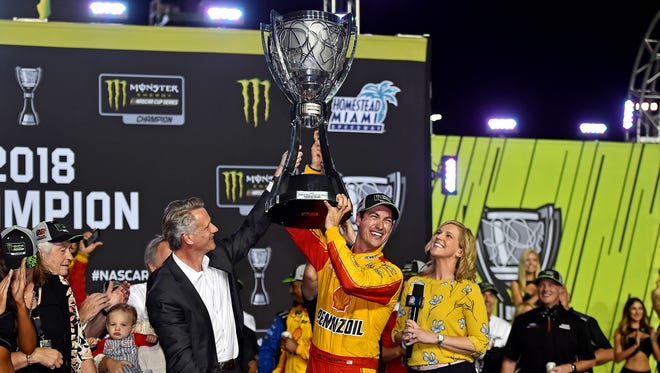 Joey Logano celebrates after winning the 2018 NASCAR Cup Series championship, his first title on the series' top level.