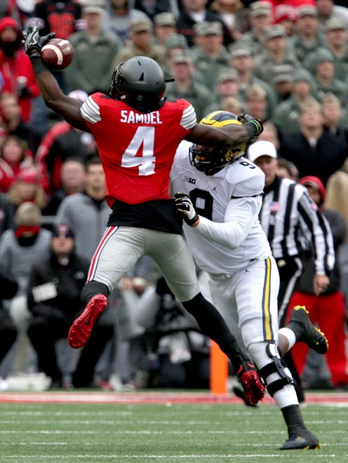 Ohio State's Curtis Samuel tries to catch the football with Michigan's Mike McCray in coverage at Ohio Stadium on Saturday, Nov. 26, 2016.