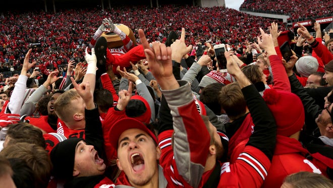 Ohio State fans swarmed the field celebrating their team's win in two overtimes in a 30-27 win over Michigan at Ohio Stadium in Columbus, Ohio on Saturday, November 26, 2016.