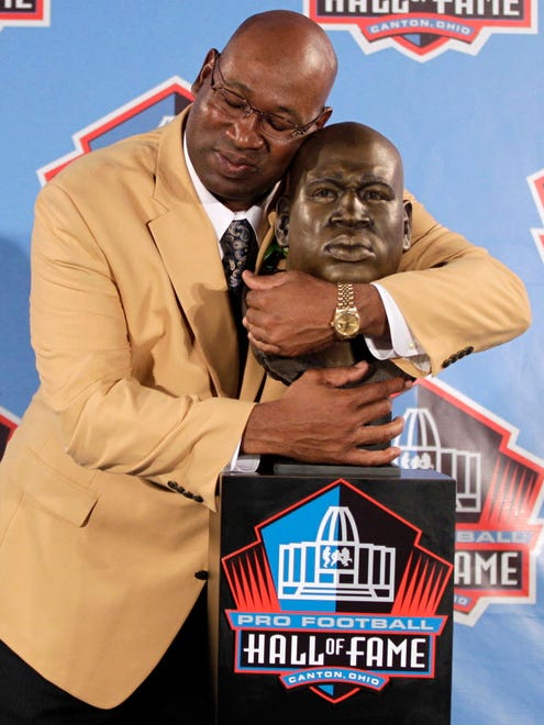 Cortez Kennedy poses with his Pro Football Hall of Fame bust.