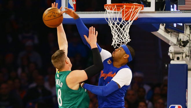 New York Knicks forward Carmelo Anthony (7) blocks a shot by by Boston Celtics forward Jonas Jerebko (8) during the first half at Madison Square Garden.